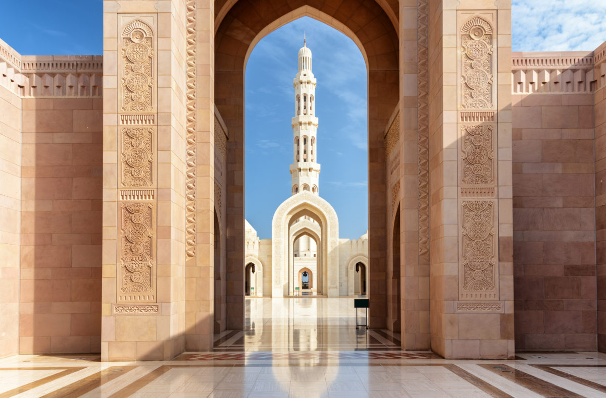 Blick Minarett durch die Bögen der Großen Moschee Sultan Qaboos in Muscat, Oman